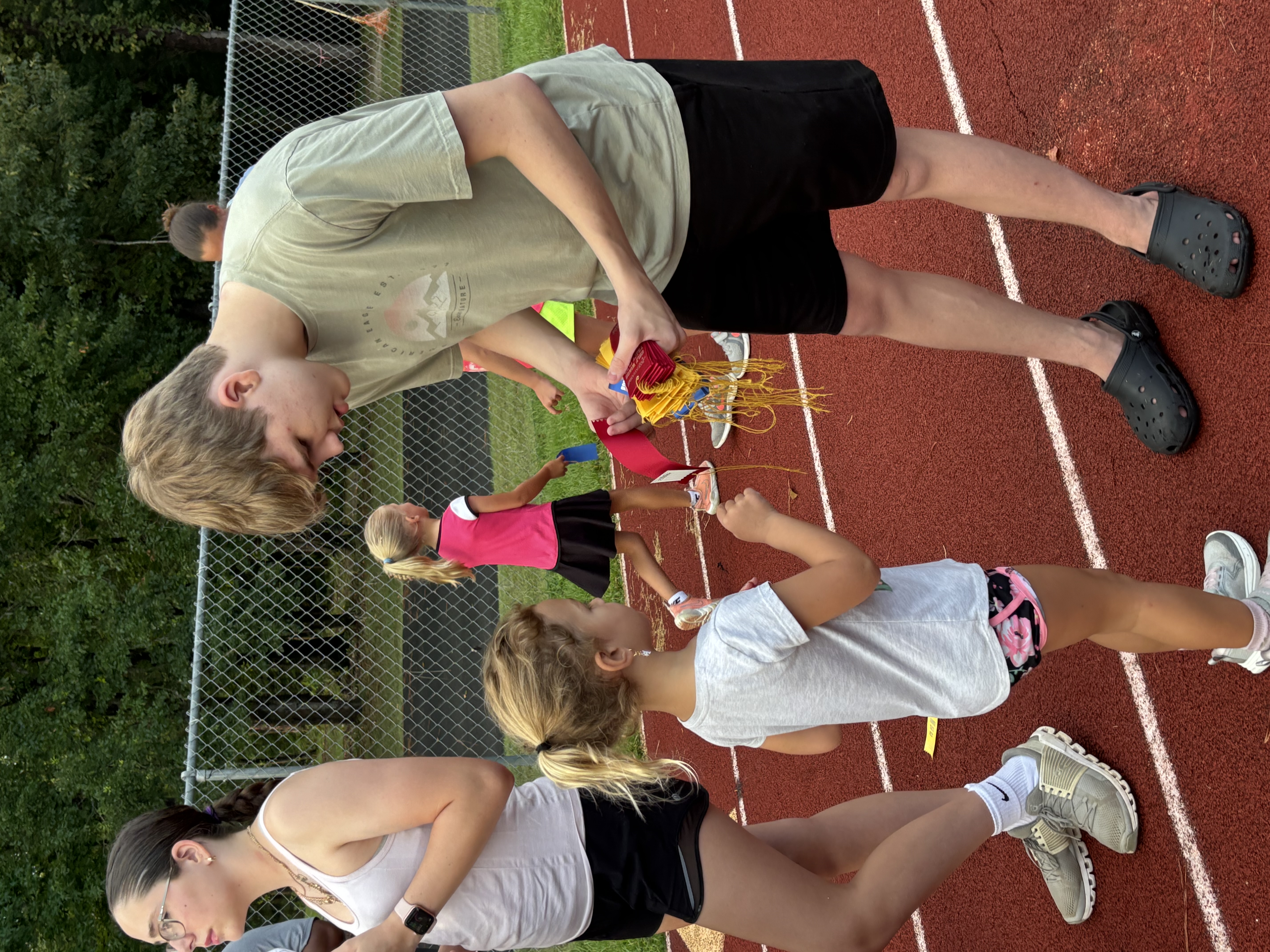 Athletes gathered together at a community event, smiling and connecting with one another in a supportive environment