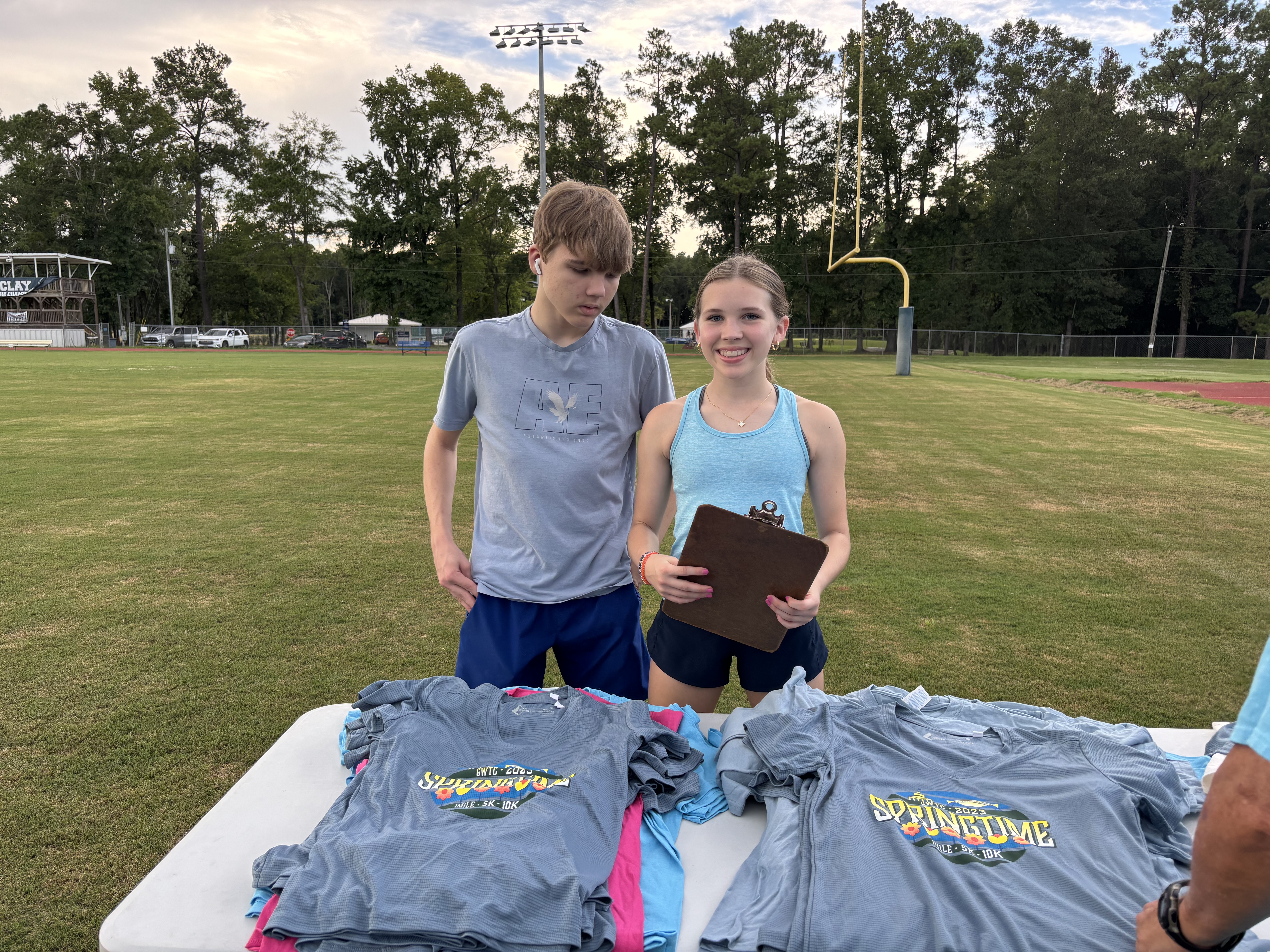 Athletes participating in a volunteer fundraising event, actively engaged in community service work together in an outdoor setting, demonstrating dedication and teamwork