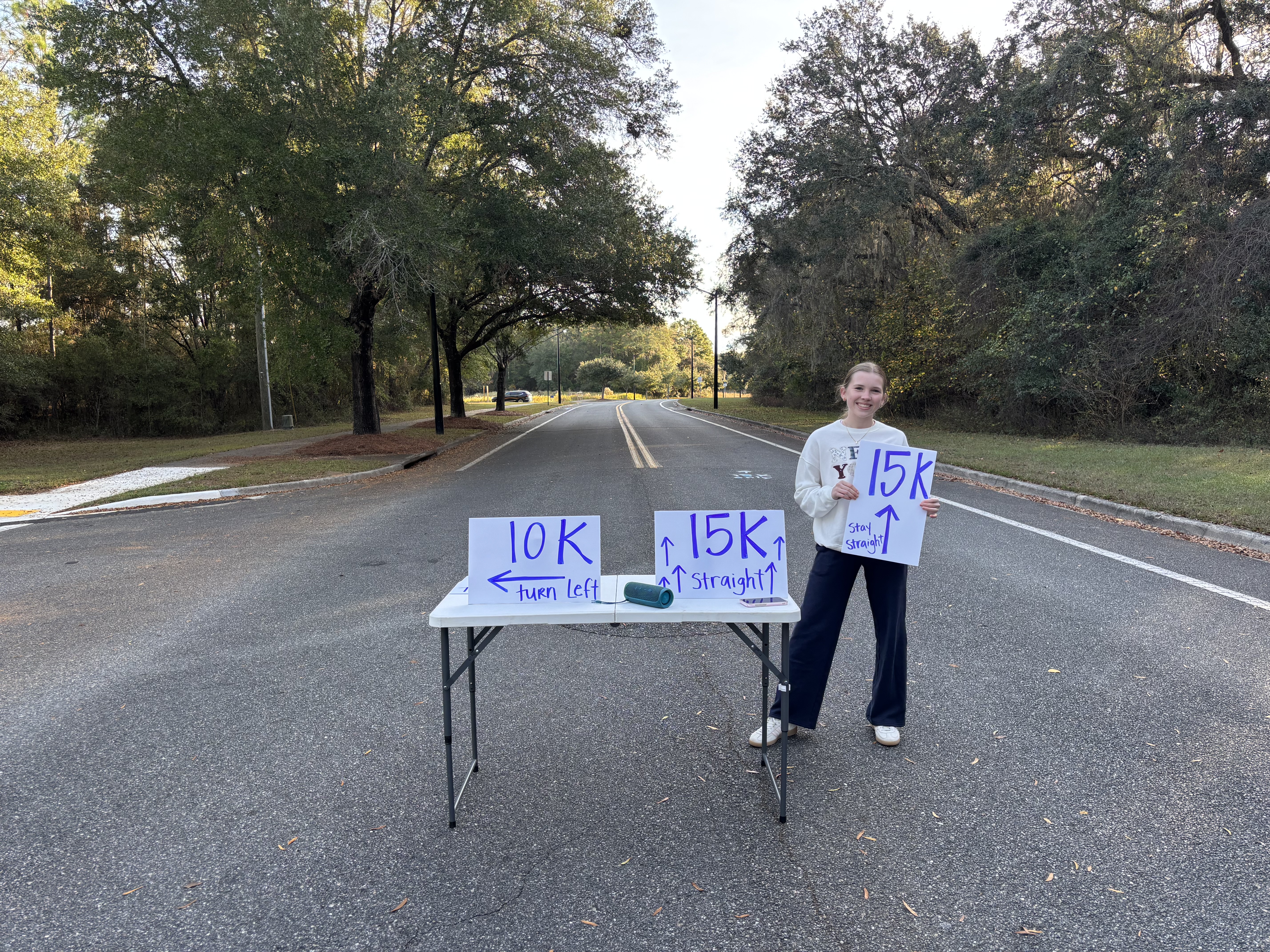 Athletes and community members participating in a service activity together, showing collaboration and positive impact in an outdoor community setting