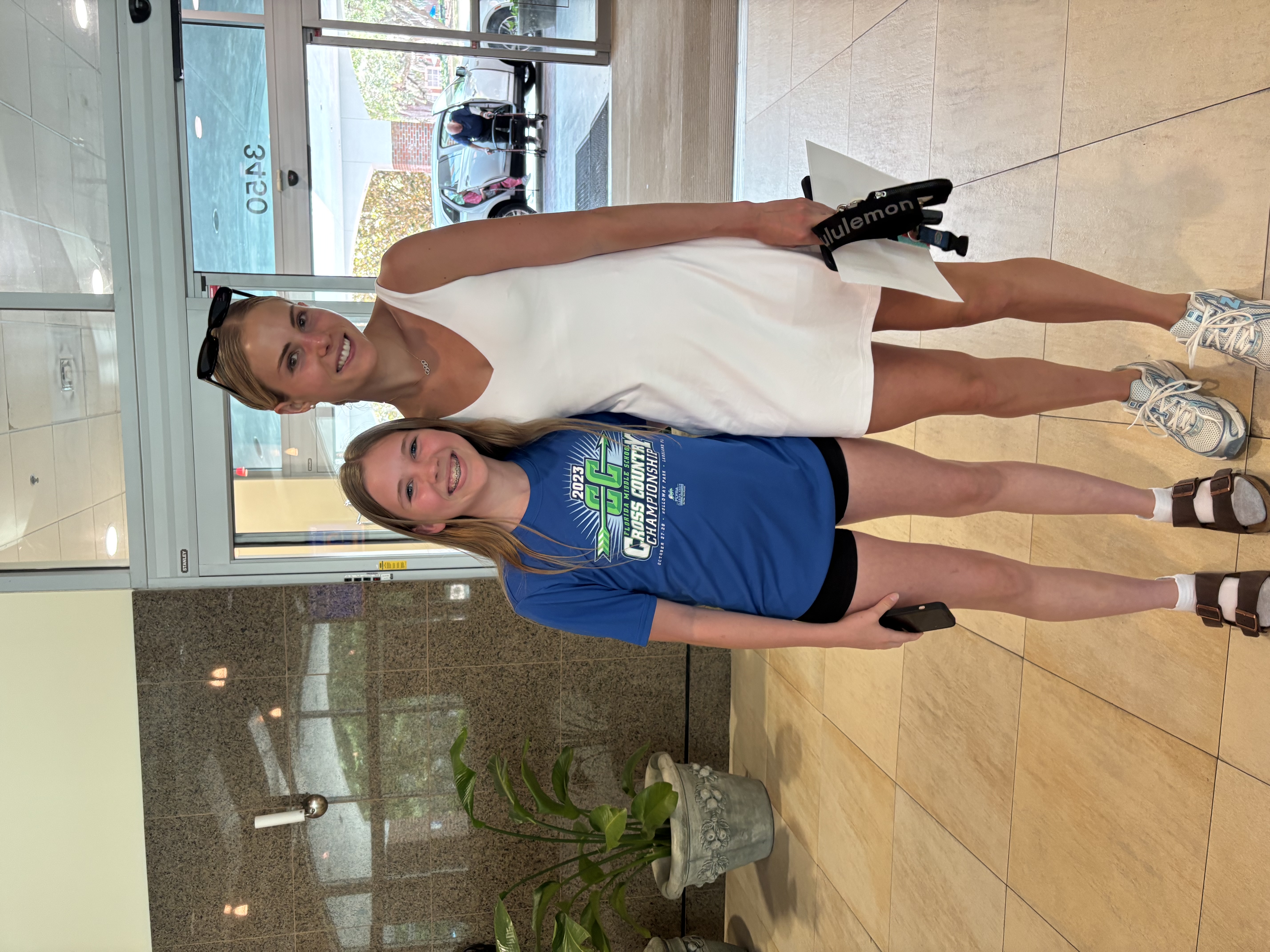 Athletes and supporters celebrating together at a community event, demonstrating joy and camaraderie in an outdoor setting with visible enthusiasm and positive energy