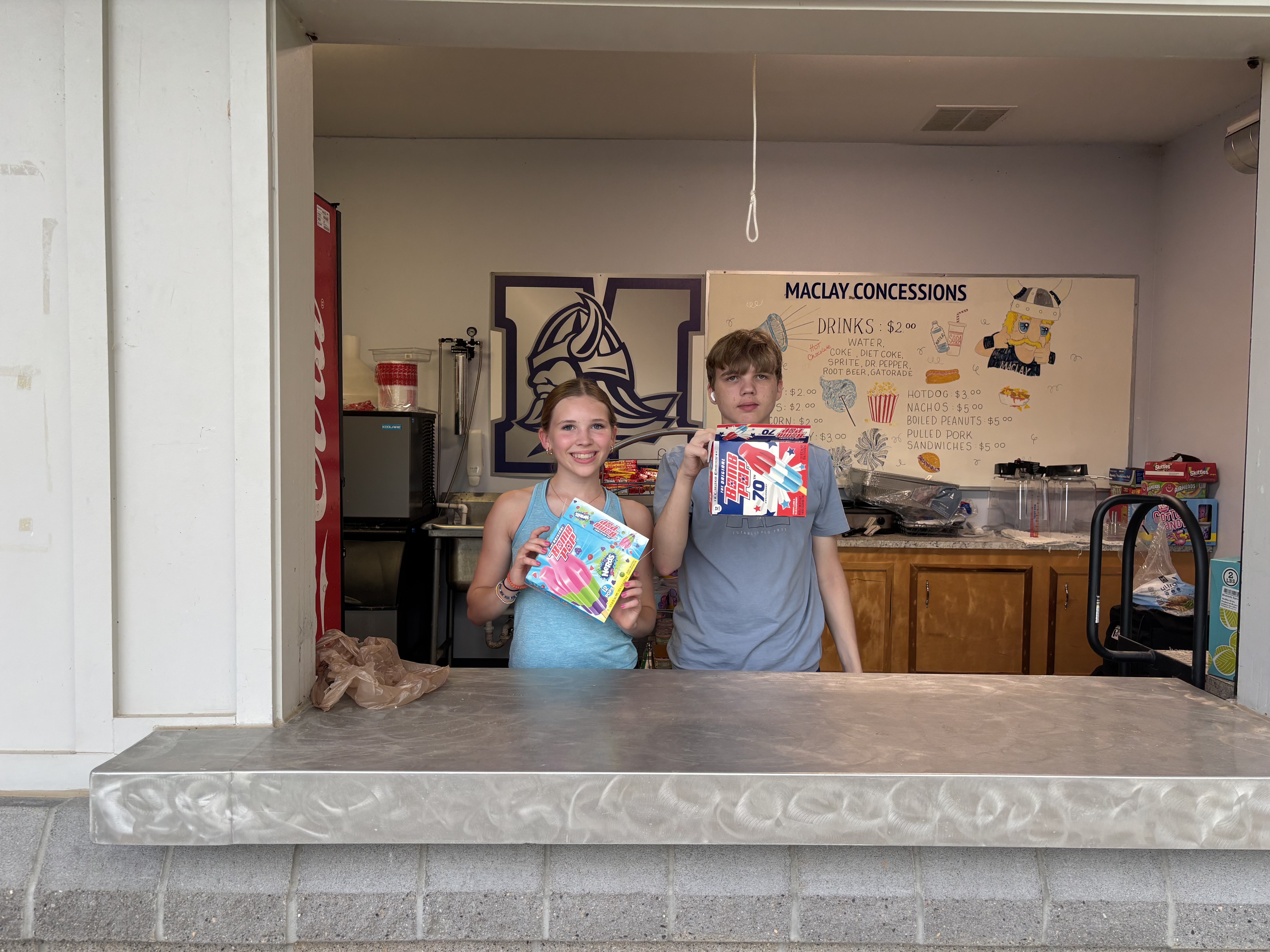 Athletes and community members engaged in a meaningful volunteer activity together, demonstrating compassion and service, set against an outdoor community backdrop with visible expressions of purpose and connection