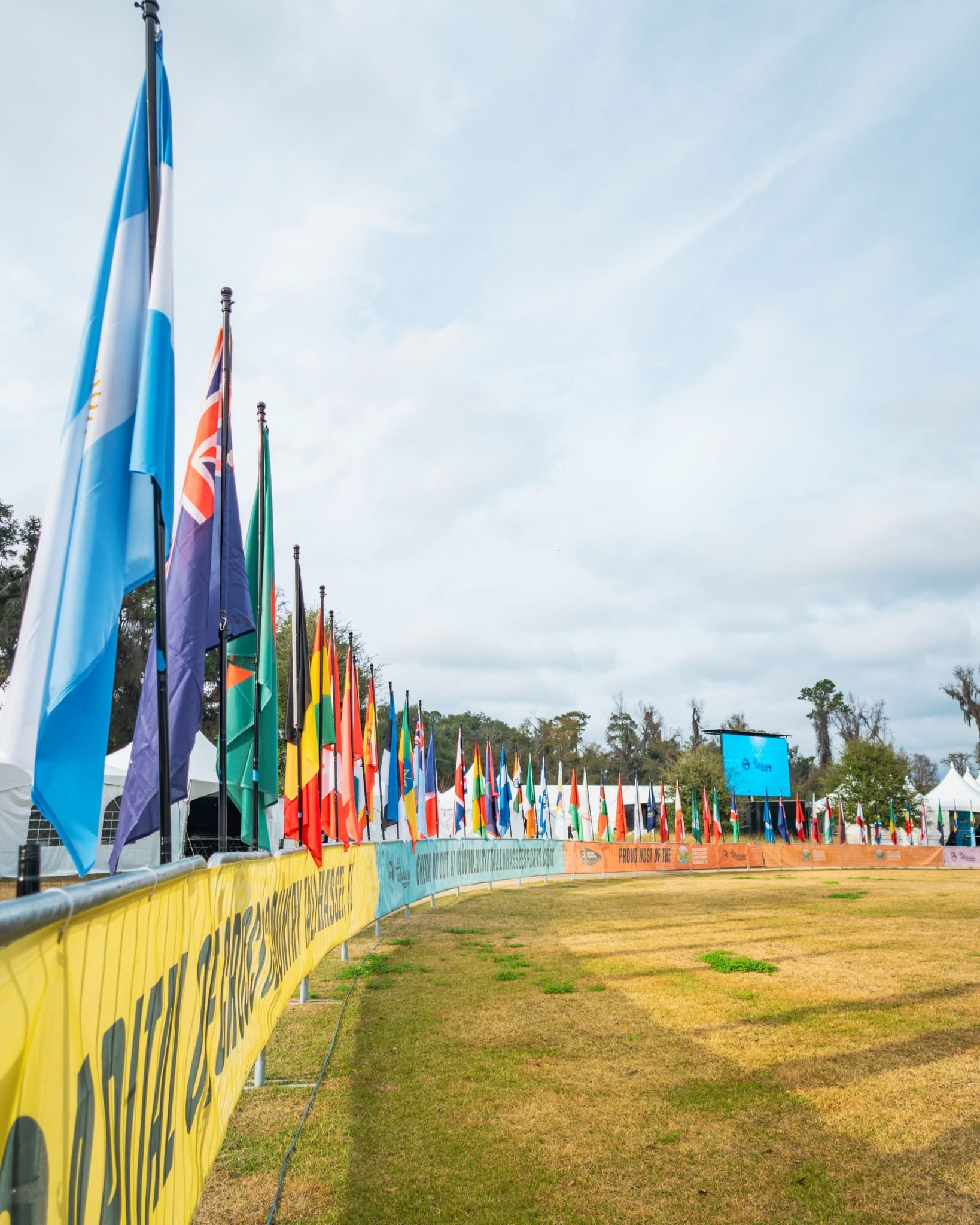 Athletes and community members gathered together at an outdoor event, engaged in volunteer work and meaningful connection, demonstrating teamwork, compassion, and shared purpose within a supportive community environment